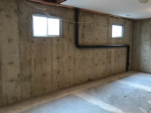 This image shows a basement in its pre-repair condition,. The basement, located in Spokane Valley, WA, illustrates common issues such as moisture intrusion and structural damage. This 'before' snapshot highlights the need for professional repair and waterproofing to restore the basement's integrity and prevent future problems.