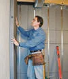 Basement wall insulation installation in progress, showing new insulation being added in a home in Mead near North Division Street