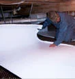 Installing crawl space floor insulation in a home in Athol, ID