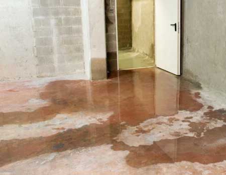 Image of a basement floor leak, emphasizing the need for waterproofing solutions to protect against water damage.