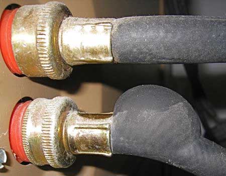 Photograph depicting a burst washing machine hose, highlighting the need for regular inspection and maintenance to prevent water damage.