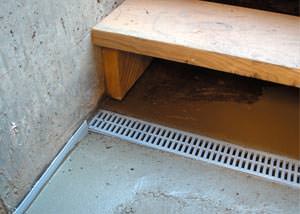 Basement stair drain installed to manage water flow, with a focus on functionality in a home in Post Falls near East Seltice Way