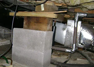 Crawl space post shimming before service in Sagle, ID showing uneven support