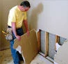 Finished basement wall repair highlighting restored structure and smooth finish in a home in Post Falls near Spokane Street