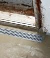 Grated drain pipe installed to improve water flow and prevent clogging, shown in a home in Spokane Valley near East Sprague Avenue