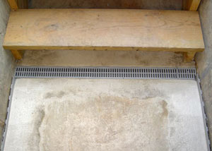 Grated basement stair drain installed in a home in Downtown Spokane, WA near West Main Avenue and North Stevens Street"