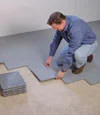 Installing sub-floor tiles to provide a durable and insulated foundation in a basement in Spokane Valley near Sprague Avenue