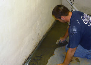 Installing a weeping tile drain system to manage water flow and prevent basement flooding, in a residence in Post Falls near Spokane Street